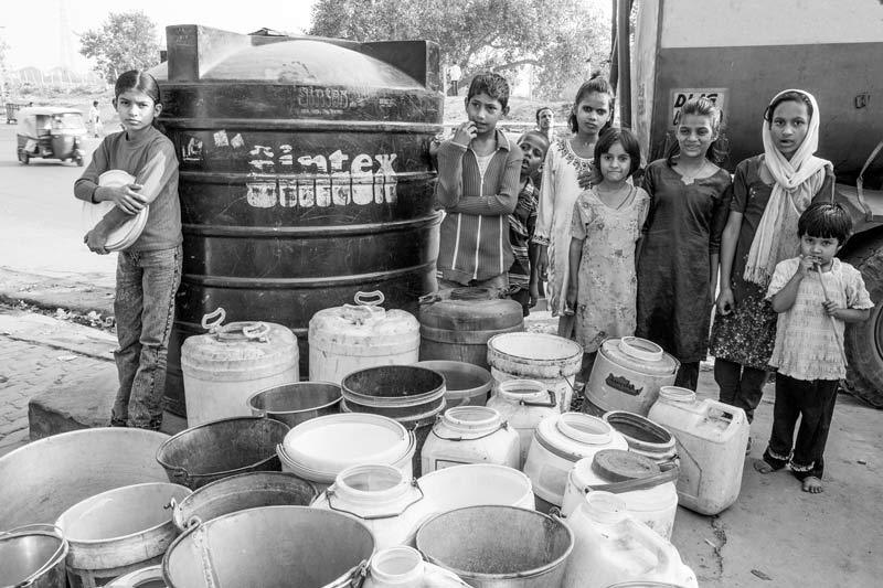 Human Right to Water in Delhi - Left without water after a long wait at a tanker water distribution point in a slum in Delhi